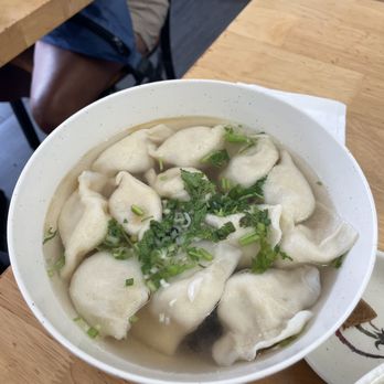 Yuanbao Jiaozi signature dishes Pork and Napa Cabbage Dumplings, Lamb and Green Onion Dumplings, Shrimp, Egg, and Chive Dumplings, Pan-Fried Pork Buns